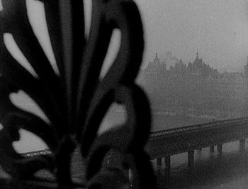 Movie still from “Of Human Bondage” (1934), directed by John Cromwell – A black and white photo of a bridge in the fog; Wide shot, Low angle