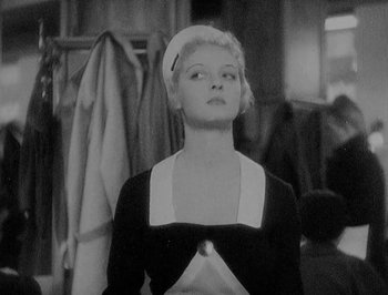 Movie still from “Of Human Bondage” (1934), directed by John Cromwell – A black and white photo of a woman in a maid's uniform; Medium shot, Low angle