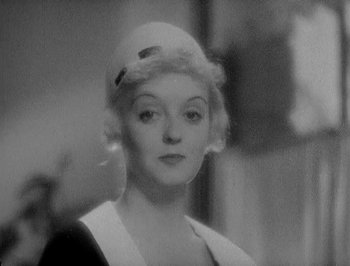 Movie still from “Of Human Bondage” (1934), directed by John Cromwell – An old black and white photo of a woman; Close Up shot, High angle