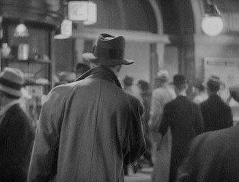 Movie still from “Of Human Bondage” (1934), directed by John Cromwell – Black and white photograph of a man wearing a hat; Medium shot, Low angle