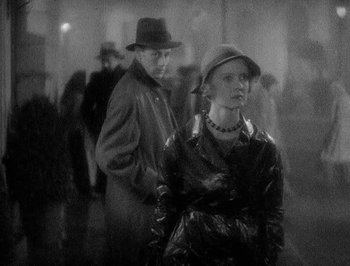 Movie still from “Of Human Bondage” (1934), directed by John Cromwell – A man and a woman standing next to each other; Medium shot, Low angle