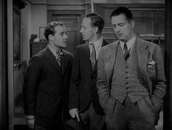 Movie still from “Of Human Bondage” (1934), directed by John Cromwell – A group of men standing next to each other in a room; Medium shot, Low angle