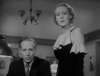 Movie still from “Of Human Bondage” (1934), directed by John Cromwell – A man and a woman are standing next to each other; Medium shot, Low angle