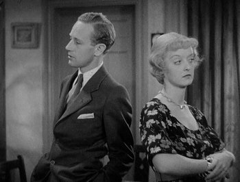 Movie still from “Of Human Bondage” (1934), directed by John Cromwell – A man and a woman standing next to each other; Medium shot, High angle