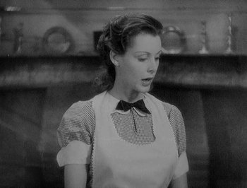 Movie still from “Of Human Bondage” (1934), directed by John Cromwell – A black and white photo of a woman in a kitchen; Close Up shot, Low angle