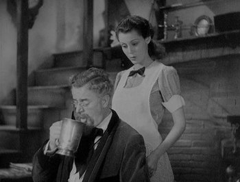 Movie still from “Of Human Bondage” (1934), directed by John Cromwell – A man and a woman standing next to each other; Medium shot, Low angle