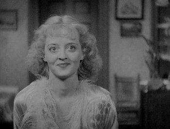 Movie still from “Of Human Bondage” (1934), directed by John Cromwell – A black - and - white photo of a woman in a white dress; Close Up shot, High angle