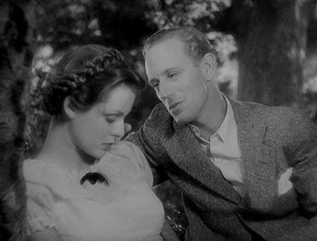 Movie still from “Of Human Bondage” (1934), directed by John Cromwell – A man and a woman sitting next to each other; Close Up shot, High angle