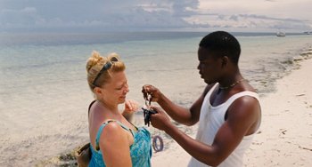 Movie still from “Paradise: Love” (2012), directed by Ulrich Seidl – A man and a woman on the beach; Medium shot, High angle