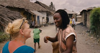 Movie still from “Paradise: Love” (2012), directed by Ulrich Seidl – Two people talking to each other on a dirt road; Medium shot, Over the shoulder angle