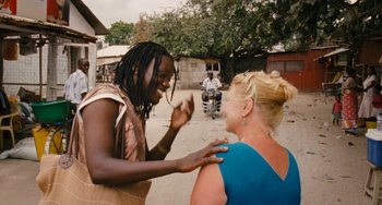 Movie still from “Paradise: Love” (2012), directed by Ulrich Seidl – A woman is talking to another woman on the street; Medium shot, Over the shoulder angle