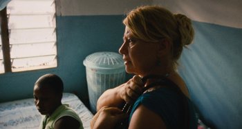 Movie still from “Paradise: Love” (2012), directed by Ulrich Seidl – A woman is holding a phone in her hand; Close Up shot, Over the shoulder angle