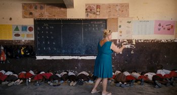 Movie still from “Paradise: Love” (2012), directed by Ulrich Seidl – A woman standing in front of a chalkboard; Wide shot, High angle
