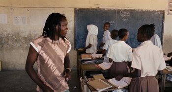 Movie still from “Paradise: Love” (2012), directed by Ulrich Seidl – A group of children in a classroom with papers on the desks; Medium shot, Over the shoulder angle