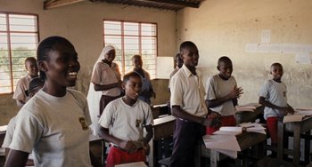 Movie still from “Paradise: Love” (2012), directed by Ulrich Seidl – A group of people standing in a room; Medium shot, Over the shoulder angle