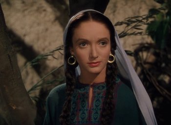 Movie still from “Samson and Delilah” (1949), directed by Cecil B. DeMille – A woman with long braids wearing a green dress; Close Up shot, Over the shoulder angle