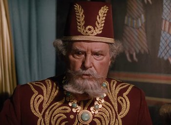 Movie still from “Samson and Delilah” (1949), directed by Cecil B. DeMille – An old man with a beard wearing a red and gold outfit; Close Up shot, High angle