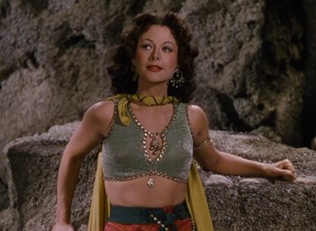 Movie still from “Samson and Delilah” (1949), directed by Cecil B. DeMille – A woman wearing a green top and a yellow scarf; Medium shot, Low angle
