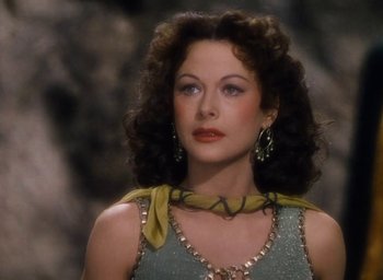 Movie still from “Samson and Delilah” (1949), directed by Cecil B. DeMille – A beautiful woman with long curly brown hair wearing jewelry; Close Up shot, High angle
