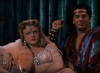 Movie still from “Samson and Delilah” (1949), directed by Cecil B. DeMille – A man and a woman dressed in costumes; Medium shot, High angle