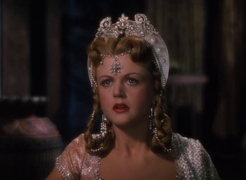 Movie still from “Samson and Delilah” (1949), directed by Cecil B. DeMille – A woman in a white dress and a tiara; Close Up shot, Over the shoulder angle
