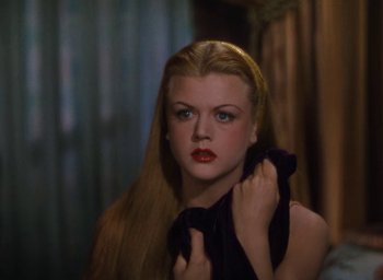 Movie still from “Samson and Delilah” (1949), directed by Cecil B. DeMille – A woman with long blonde hair and red lipstick; Close Up shot, Over the shoulder angle