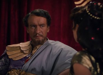 Movie still from “Samson and Delilah” (1949), directed by Cecil B. DeMille – A man and a woman in egyptian garb looking intently at each other; Medium shot, Over the shoulder angle