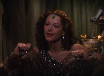 Movie still from “Samson and Delilah” (1949), directed by Cecil B. DeMille – A beautiful woman holding a pair of scissors; Close Up shot, Low angle