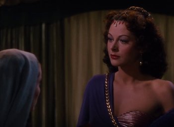 Movie still from “Samson and Delilah” (1949), directed by Cecil B. DeMille – A woman in a purple dress looking at a mirror; Close Up shot, Over the shoulder angle