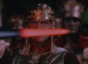 Movie still from “Samson and Delilah” (1949), directed by Cecil B. DeMille – A person holding a sword; Close Up shot, Over the shoulder angle