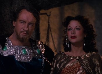 Movie still from “Samson and Delilah” (1949), directed by Cecil B. DeMille – A man and a woman standing next to each other; Medium shot, Over the shoulder angle