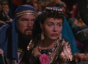 Movie still from “Samson and Delilah” (1949), directed by Cecil B. DeMille – A man and a woman dressed in medieval garb; Medium shot, Over the shoulder angle