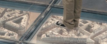 Movie still from “Simon Killer” (2012), directed by Antonio Campos – A person is standing on the edge of a building; Wide shot, Overhead angle