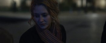 Movie still from “Simon Killer” (2012), directed by Antonio Campos – A person wearing a scarf on the street; Close Up shot, Over the shoulder angle