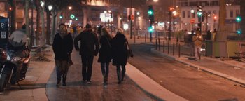Movie still from “Simon Killer” (2012), directed by Antonio Campos – Two people walking down a street at night; Wide shot, High angle