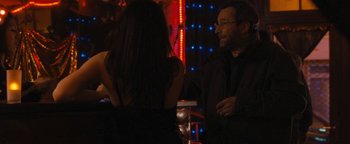 Movie still from “Simon Killer” (2012), directed by Antonio Campos – A man and a woman are talking in a bar; Medium shot, Over the shoulder angle