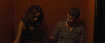 Movie still from “Simon Killer” (2012), directed by Antonio Campos – A man and a woman sitting next to each other; Medium shot, High angle