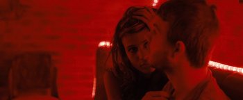 Movie still from “Simon Killer” (2012), directed by Antonio Campos – A man and a woman kissing in a red room; Close Up shot, Over the shoulder angle