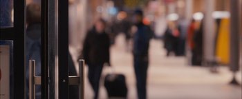 Movie still from “Simon Killer” (2012), directed by Antonio Campos – A blurry image of people walking down a street; Extreme Close Up shot, Over the shoulder angle