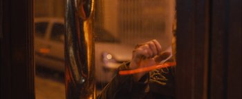 Movie still from “Simon Killer” (2012), directed by Antonio Campos – A person is holding a frisbee in their hand; Close Up shot, Over the shoulder angle