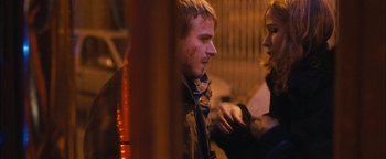 Movie still from “Simon Killer” (2012), directed by Antonio Campos – A man and a woman standing next to each other on a street; Close Up shot, Over the shoulder angle