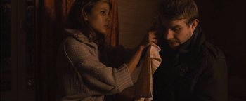 Movie still from “Simon Killer” (2012), directed by Antonio Campos – A man and a woman are holding a towel; Medium shot, Over the shoulder angle