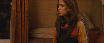 Movie still from “Simon Killer” (2012), directed by Antonio Campos – A young woman wearing a sweater and a scarf; Close Up shot, Over the shoulder angle