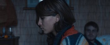 Movie still from “Simon Killer” (2012), directed by Antonio Campos – A person wearing a sweater; Close Up shot, Over the shoulder angle