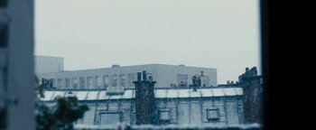 Movie still from “Simon Killer” (2012), directed by Antonio Campos – A building that is covered in snow in the winter; Extreme Wide shot, Low angle