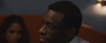 Movie still from “Simon Killer” (2012), directed by Antonio Campos – A man's face in a dark room; Close Up shot, High angle