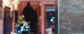 Movie still from “Simon Killer” (2012), directed by Antonio Campos – A blurry picture of a person in a room; Extreme Close Up shot, Over the shoulder angle