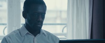 Movie still from “Simon Killer” (2012), directed by Antonio Campos – A person sitting in front of a laptop; Close Up shot, Over the shoulder angle