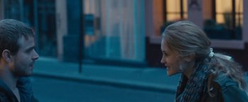 Movie still from “Simon Killer” (2012), directed by Antonio Campos – A woman smiles as she walks down the street; Close Up shot, Over the shoulder angle