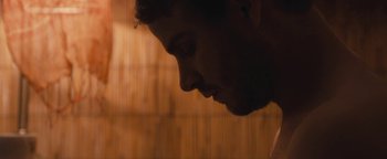 Movie still from “Simon Killer” (2012), directed by Antonio Campos – A man's face in the dark; Extreme Close Up shot, Over the shoulder angle